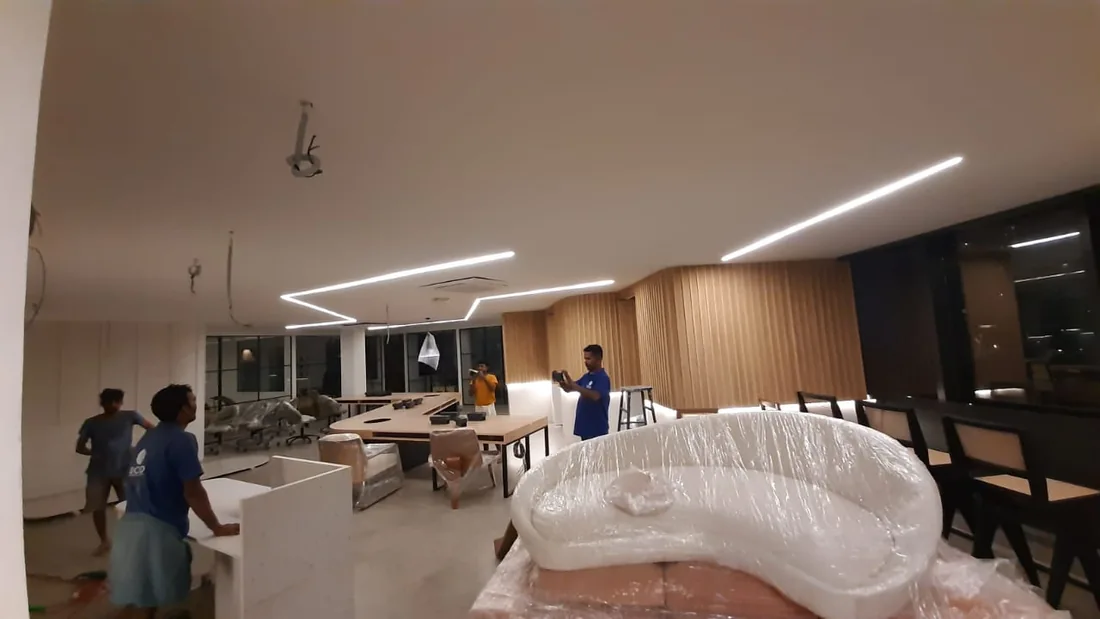 Commercial interior installation in progress with linear ceiling lighting