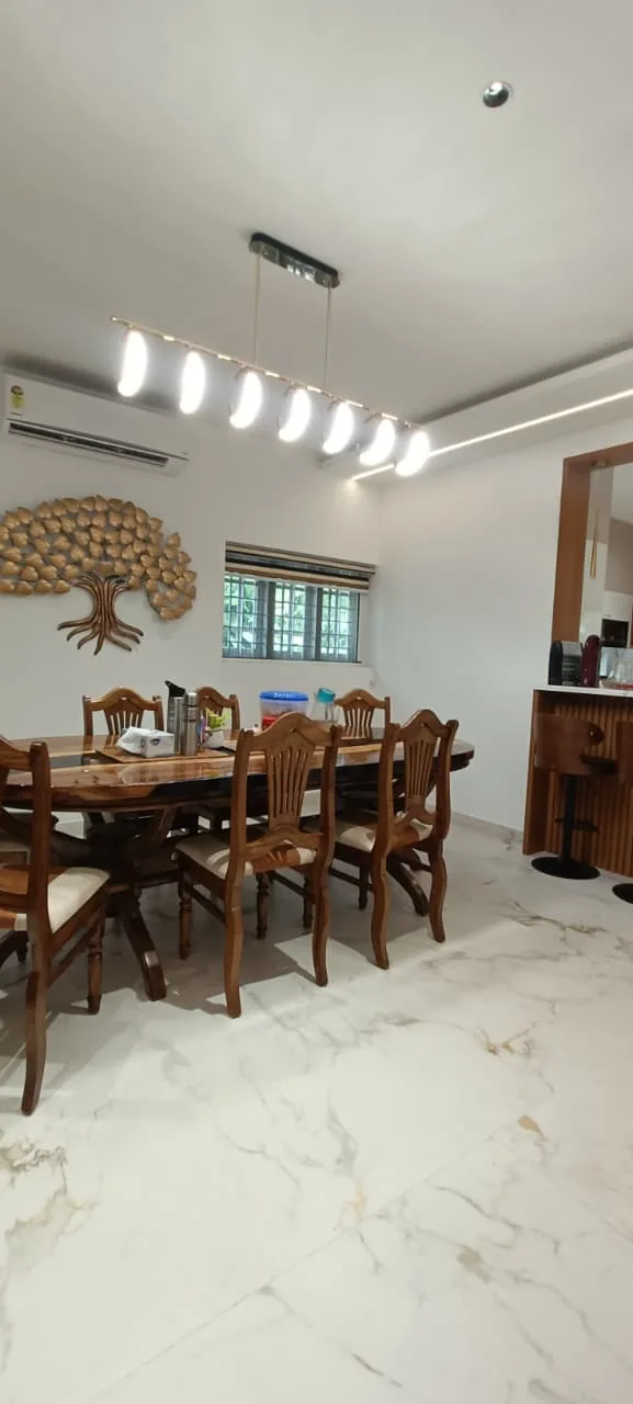 Dining room with a timber table, chairs, decorative wall art and a sideboard