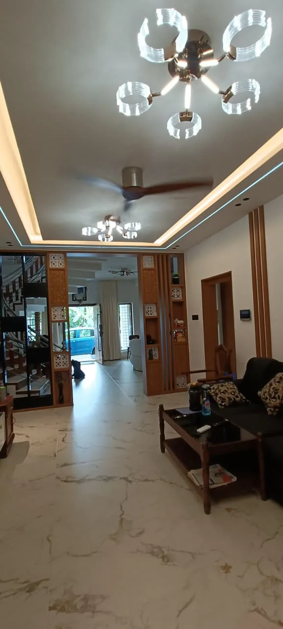 Home entrance and dining area with a detailed ceiling, lighting and timber finishes