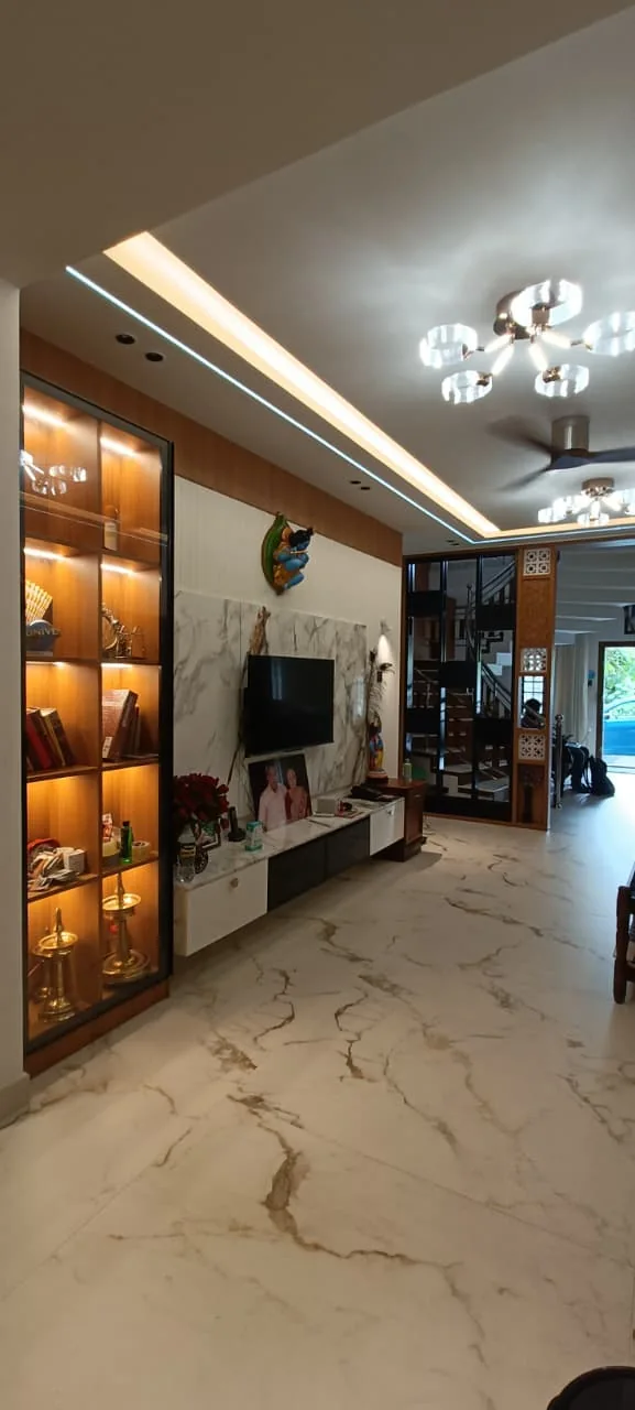 Living room TV wall with timber detailing, display shelves and accent lighting