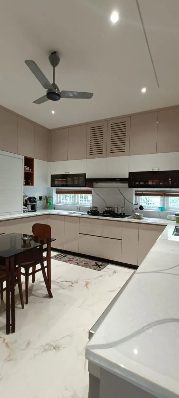 Modern kitchen with upper and lower storage cabinets, cooking area and integrated lighting