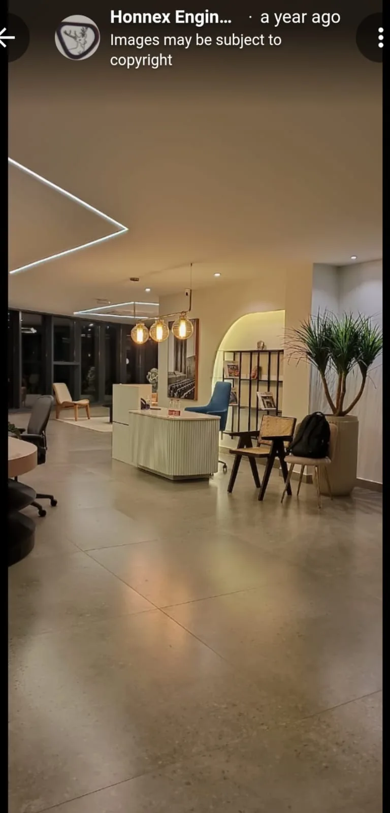 Showroom reception and seating area with pendant lighting and display partitions